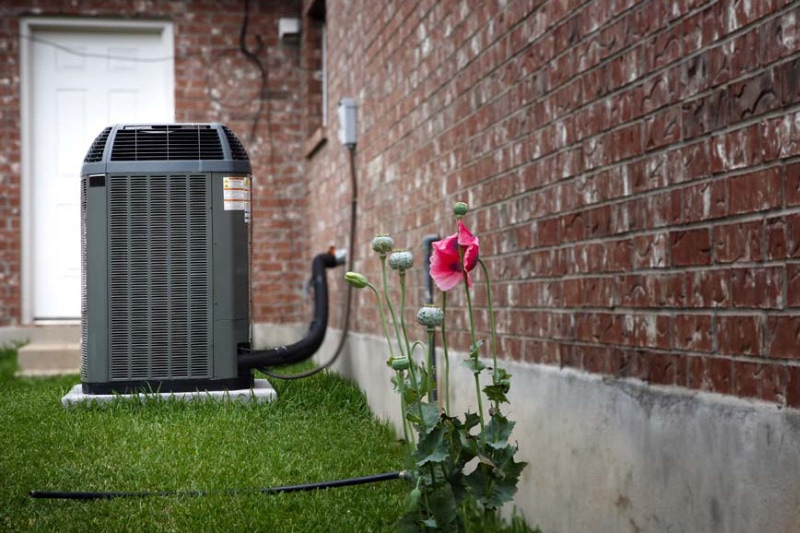 Blog Title : How Does an Air Conditioner Work? Photo: AC unit outside of a home