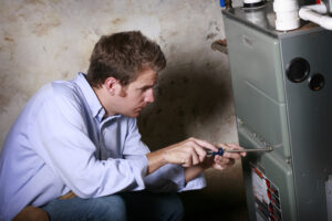 What Is an Air Handler? Service Man Working on Furnace.