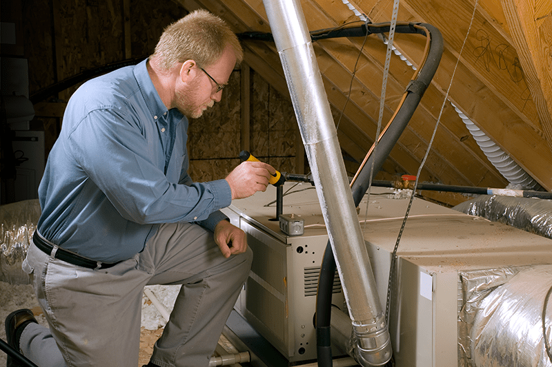 Man fixing furnace. 7 Furnace Maintenance.