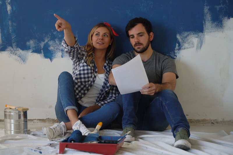 Video - Remodeling Your Home? Don't Forget Your Comfort! - Couple sits on the ground planning a remodel.