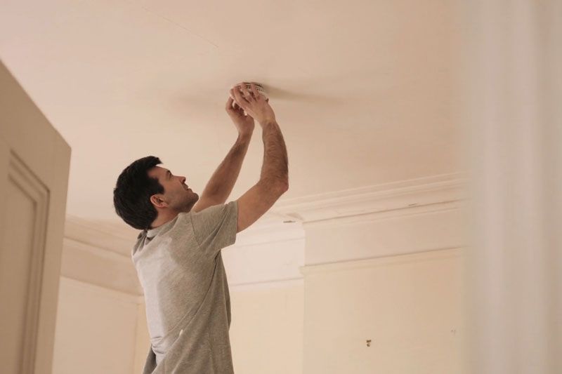 Image of someone replacing the batteries in their smoke detector. Video - When Do I Need to Replace the Batteries in My Smoke Detector?